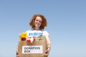 volunteer carrying food donation box