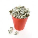 Picture of money in a garbage can