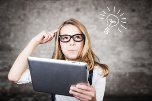 Woman thinking while holding ipad