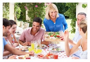 Group Of Young And Senior Couples Enjoying Family Meal