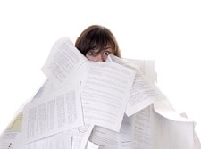 woman drowning in a mountain of papers