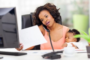 african american woman with baby girl working from home
