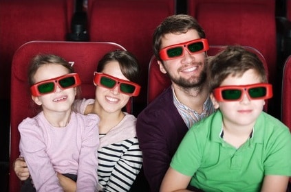 Happy family in 3D movie theater